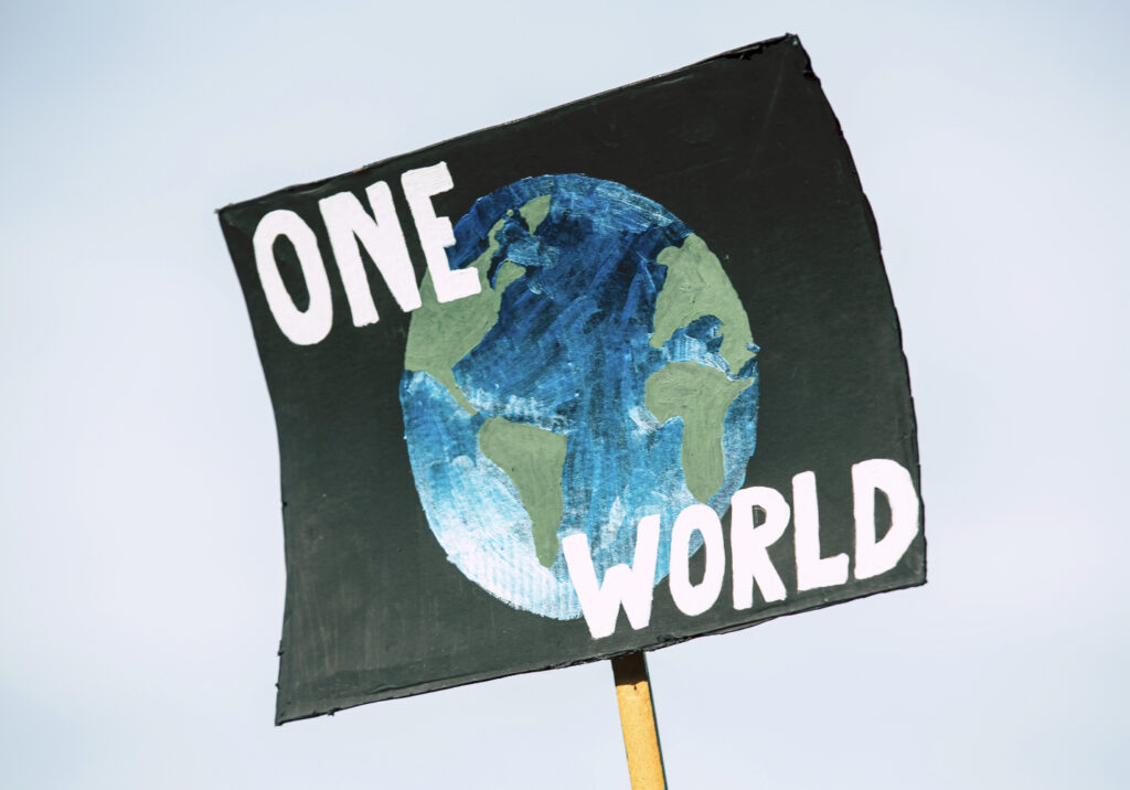 Sign with image of earth with "One World".